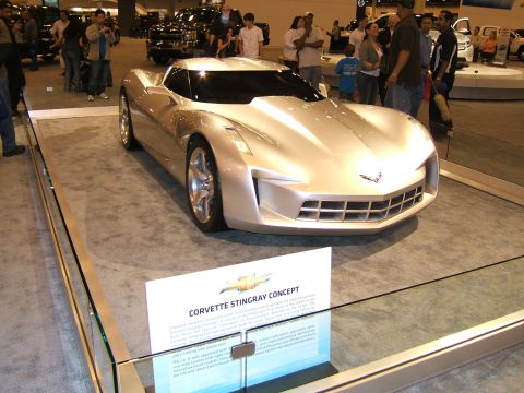 2012 Ford Crown Victoria - A silver Corvette Stingray Concept car is displayed at an auto show with informational signage.