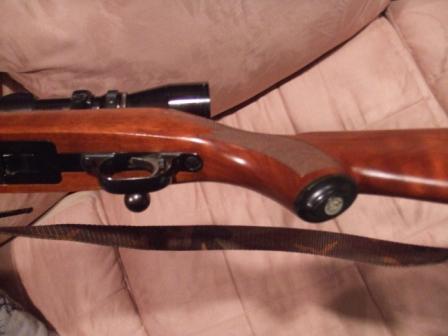 1996 Ford Bronco - Rifle with scope shown from the side, resting on a fabric surface.