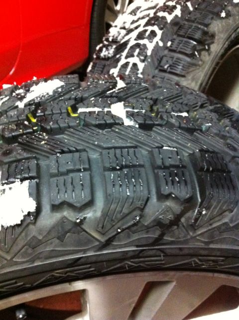 2010 Hyundai Genesis - A tire covered in snow is shown in a close-up view.