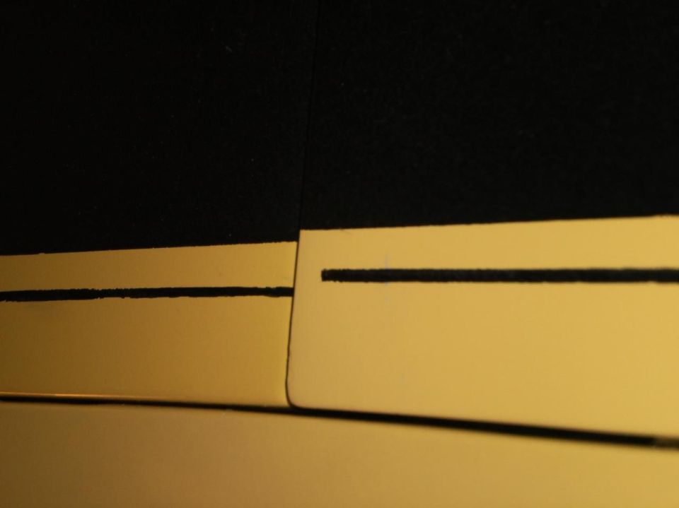 Gold stripe on black panel with Supermotors logo