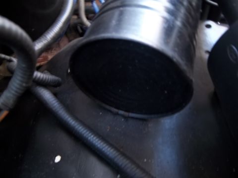 1995 Ford Bronco - Detail of an engine intake tube, showing its ribbed construction and surrounding engine components.