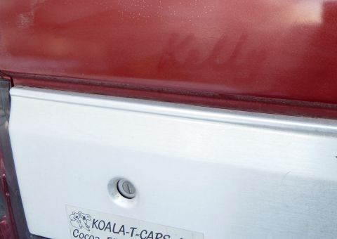 1993 Ford C-150 (Centurion Conversions) - A sticker for Koala-T-Caps is visible on the silver trim of a vehicle's rear panel.
