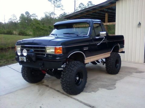 1990 Ford Bronco - This lifted Ford Bronco has a custom bumper and auxiliary lights.