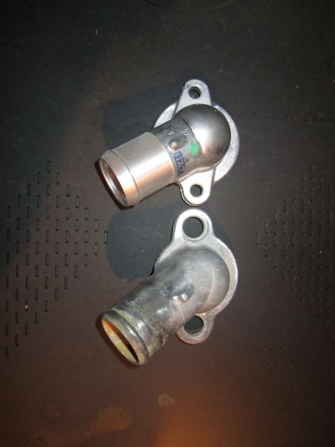 2000 Mercury Grand Marquis - Two automotive water neck housings are shown against a dark background.