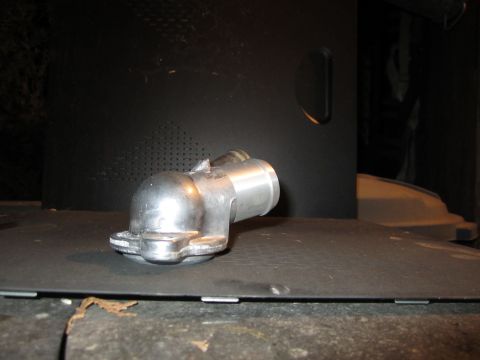 2000 Mercury Grand Marquis - A metal water neck part is shown against a dark background, with a Supermotors.net logo visible at the bottom.