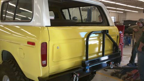 1978 Ford Bronco - Rear view of a yellow 1978 Ford Bronco with a white top and aftermarket bumper.