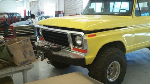 1978 Ford Bronco - Front view of a yellow 1978 Ford Bronco with its hood open, parked in a garage.