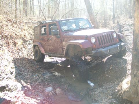 2007 Jeep Wrangler - A Jeep Wrangler tackles a challenging muddy off-road course.