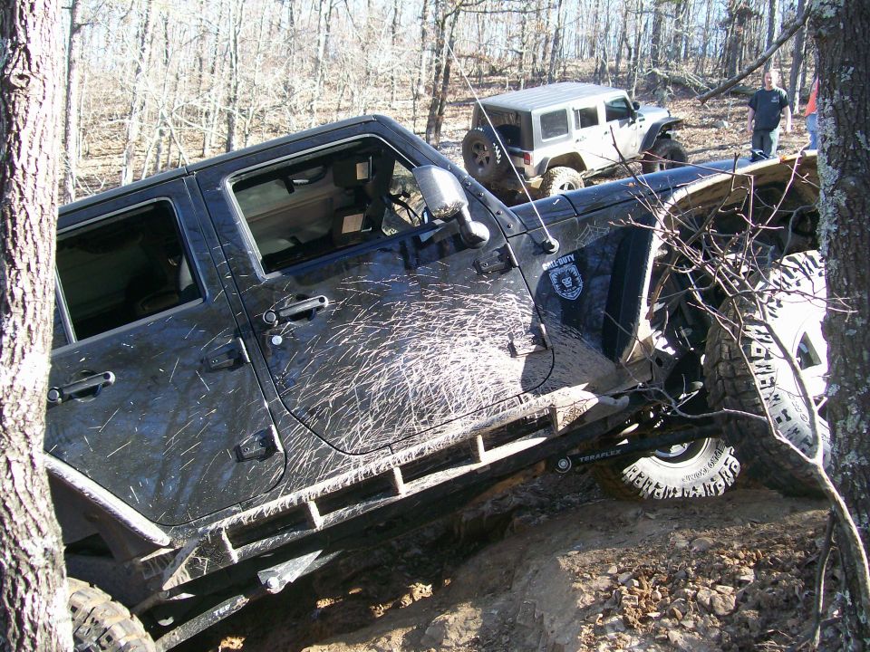 Black Jeep Wrangler with "Call of Duty" decal, off-roading with another Jeep in background