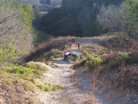 2007 Jeep Wrangler - A Jeep Wrangler navigates a challenging off-road course on a sunny day.