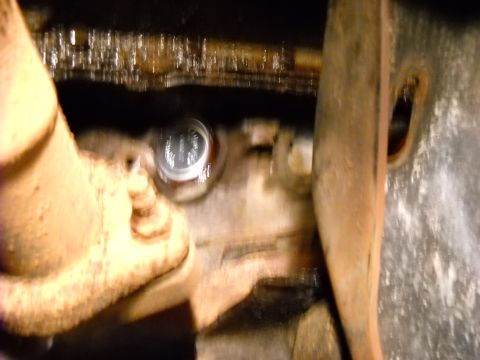 1993 Ford C-150 (Centurion Conversions) - A freeze plug is visible in this close-up engine component view.