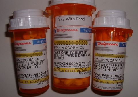 1986 Ford Bronco - Three prescription pill bottles are arranged together, with visible labels indicating medication details.