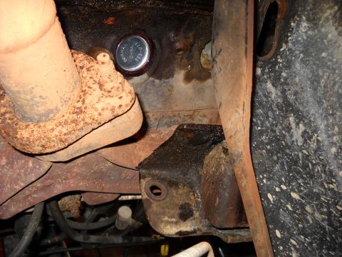 1993 Ford C-150 (Centurion Conversions) - A Dorman 550-071 freeze plug is visible on the engine block, adjacent to the exhaust system.