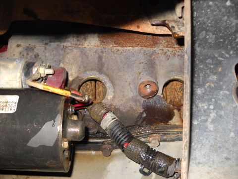 1993 Ford C-150 (Centurion Conversions) - A starter motor is shown attached to a heavily corroded engine block, with visible fluid leaks.