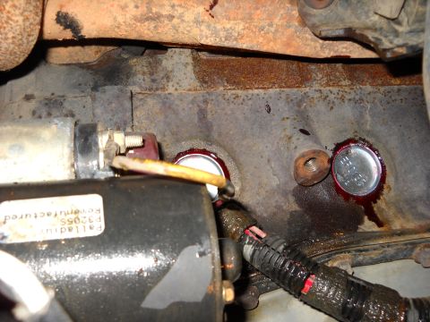 1993 Ford C-150 (Centurion Conversions) - Engine block showing two installed freeze plugs, one with red sealant visible.