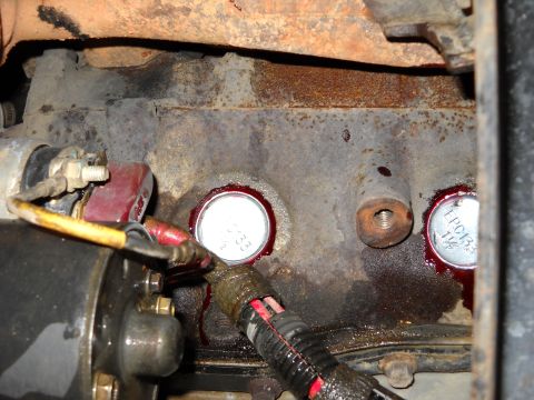 1993 Ford C-150 (Centurion Conversions) - Close-up view of engine block showing freeze plugs and associated wiring.