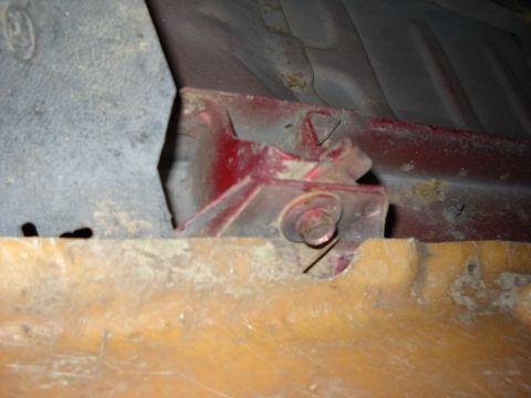 1993 Ford C-150 (Centurion Conversions) - A close-up view of a rusted metal bracket attached to the undercarriage of a vehicle.