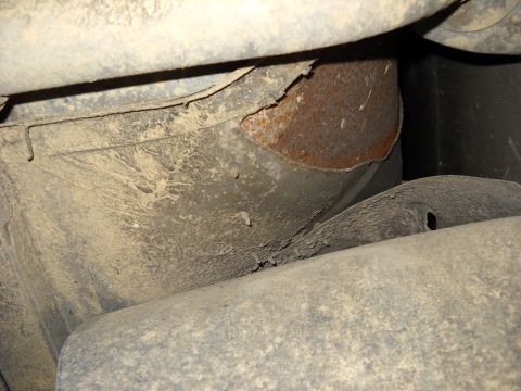1993 Ford C-150 (Centurion Conversions) - Vehicle underbody detail with visible rust and accumulated dirt.