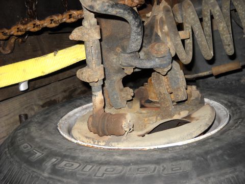1993 Ford C-150 (Centurion Conversions) - Rusty suspension part and tire detail.