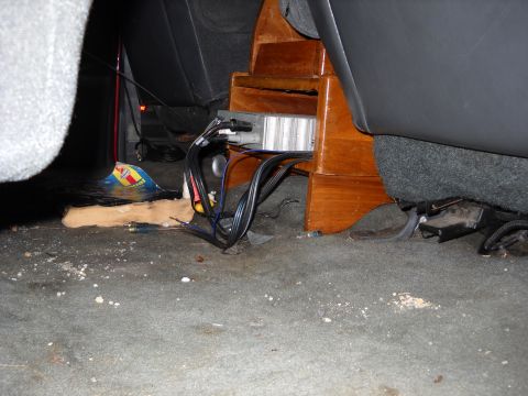1993 Ford C-150 (Centurion Conversions) - Wiring and a custom wooden console are visible in the interior of the vehicle.