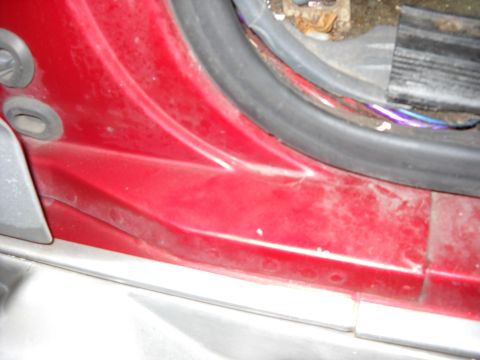 1993 Ford C-150 (Centurion Conversions) - Interior door jamb area shows red paint, rubber seal, and exposed wiring.