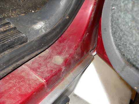 1993 Ford C-150 (Centurion Conversions) - The interior door sill of a vehicle shows signs of dirt and wear.