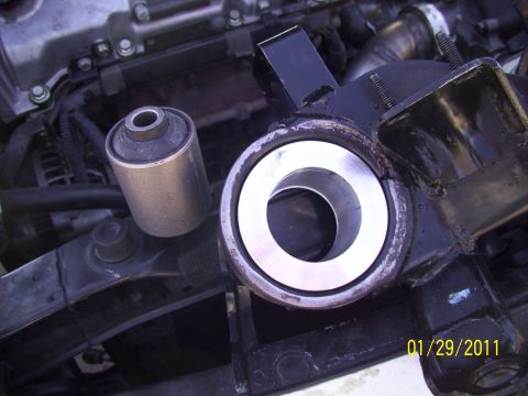 1995 Ford Probe - Close-up view of suspension bushings and a metal bracket within an engine bay, dated 01/29/2011.
