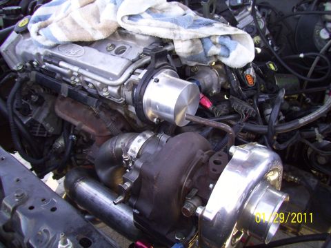 1995 Ford Probe - Custom turbo setup in an engine bay, showing the turbocharger and associated plumbing.