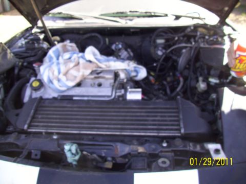 1995 Ford Probe - The engine bay of a vehicle is shown with an intercooler installed.