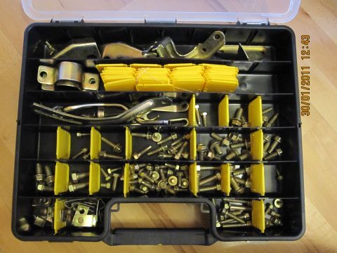 1973 Ford Ranchero - A compartmentalized case holds various metal fasteners and brackets, organized by size and type.