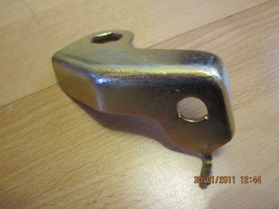 Gold-toned metal bracket with hexagonal and circular openings