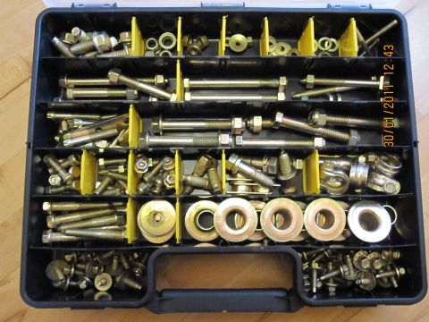 1973 Ford Ranchero - A black organizer case is filled with various metal fasteners, including bolts and washers, neatly sorted into compartments.
