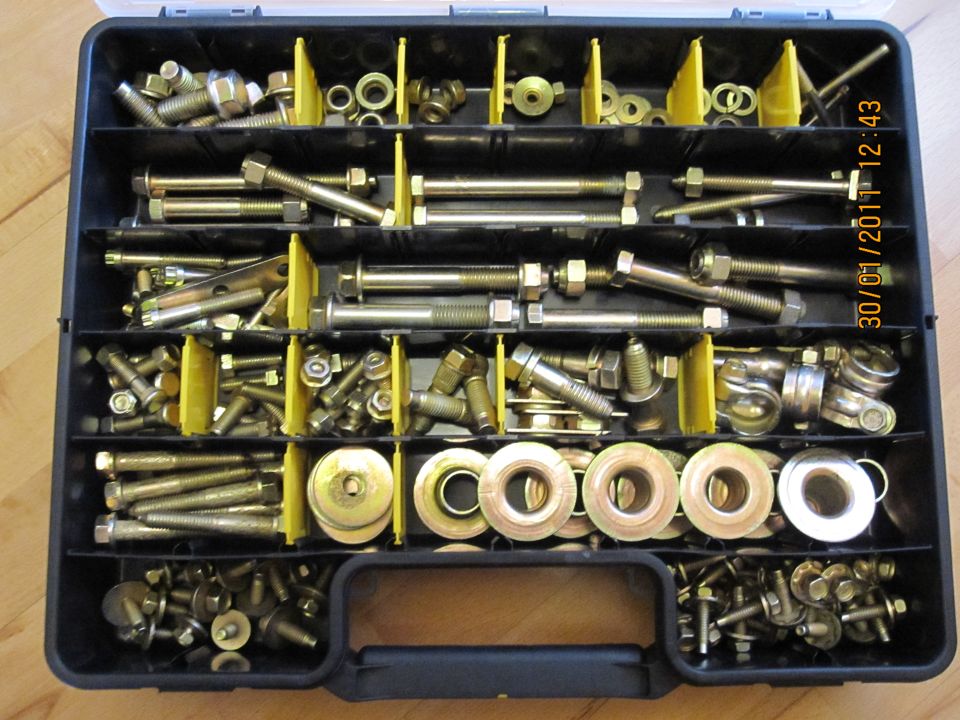 Organizer box filled with bolts, nuts, and washers. Some yellow dividers are visible