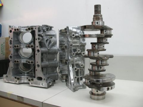 1995 Ford Probe - Engine block and crankshaft parts are laid out on a workbench.
