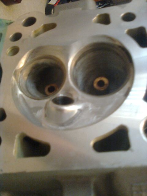 1984 Ford Bronco - Close-up of an engine cylinder head, showing intake and exhaust ports.