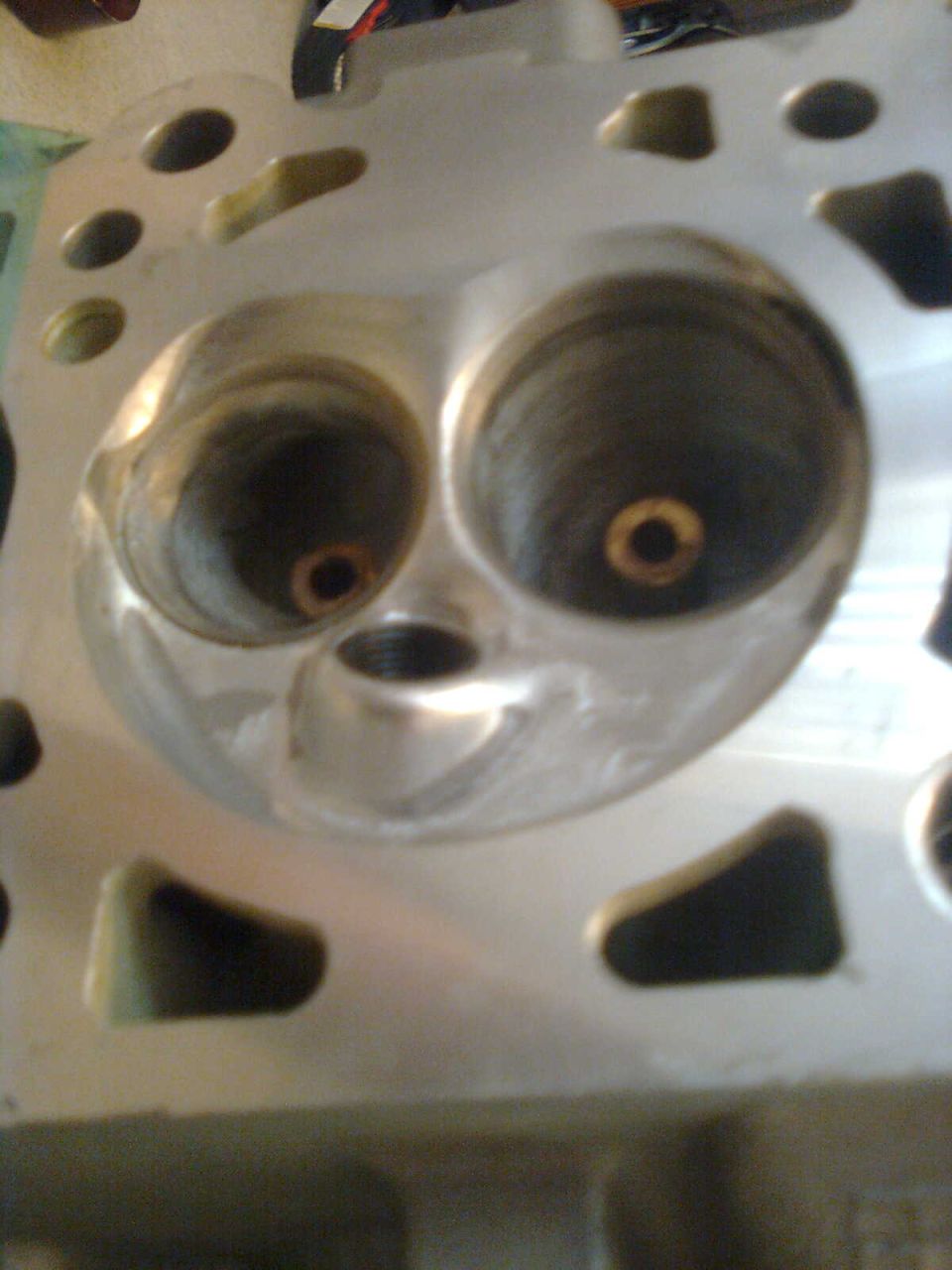 Engine cylinder head with two large intake ports and smaller exhaust ports