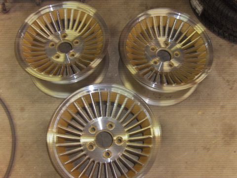 1979 Chevrolet Camaro - Three gold and silver turbine wheels are shown, possibly for a classic car.