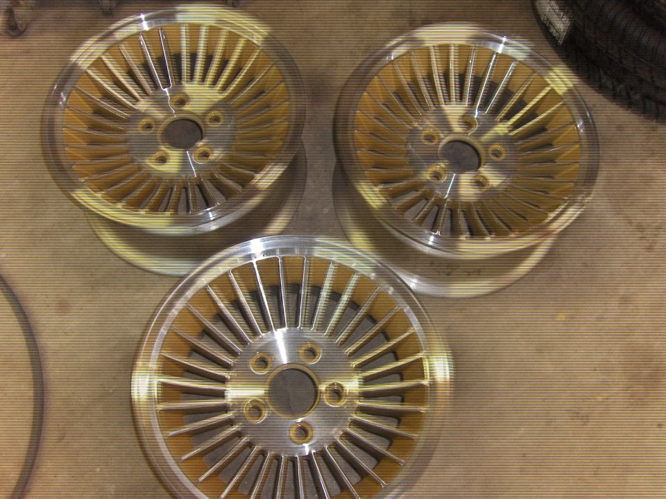 Three gold and silver turbine wheels