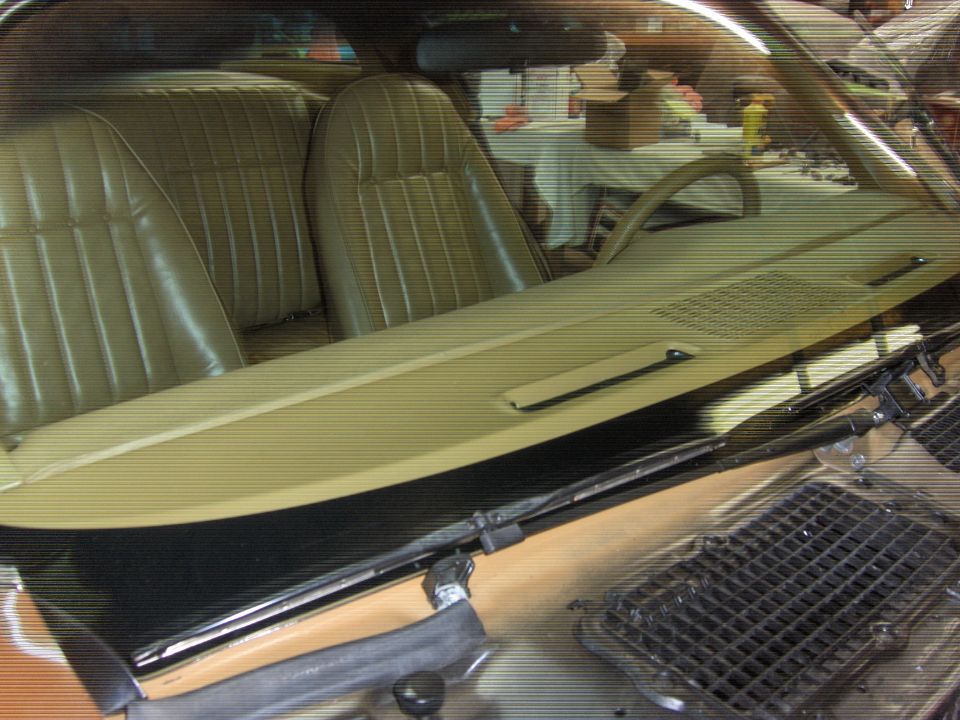 1979 Chevrolet Camaro interior with tan vinyl seats, dashboard, and steering wheel visible