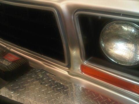 1978 Ford Bronco - Close-up of the front grille and headlight assembly of a 1978 Ford Bronco.
