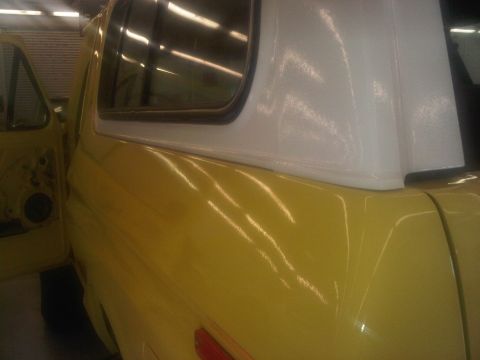 1978 Ford Bronco - This 1978 Ford Bronco features a bright yellow exterior and a white removable top, seen from a three-quarter front perspective.
