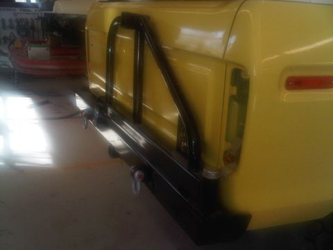 1978 Ford Bronco - Rear view of a 1978 Ford Bronco with aftermarket bumper and roll cage installed.