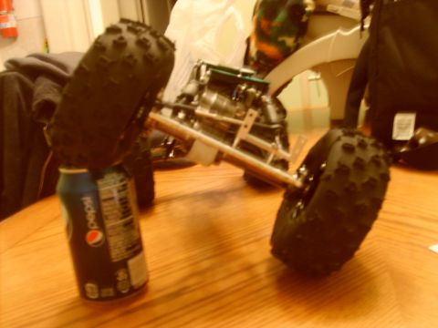 1989 Ford Bronco - This is a close-up view of a remote control car chassis, with its knobby tires resting on a Pepsi can.