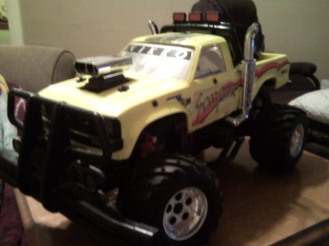 1989 Ford Bronco - This yellow remote control monster truck features a prominent scoop and 'Scorpion' graphics on the side.