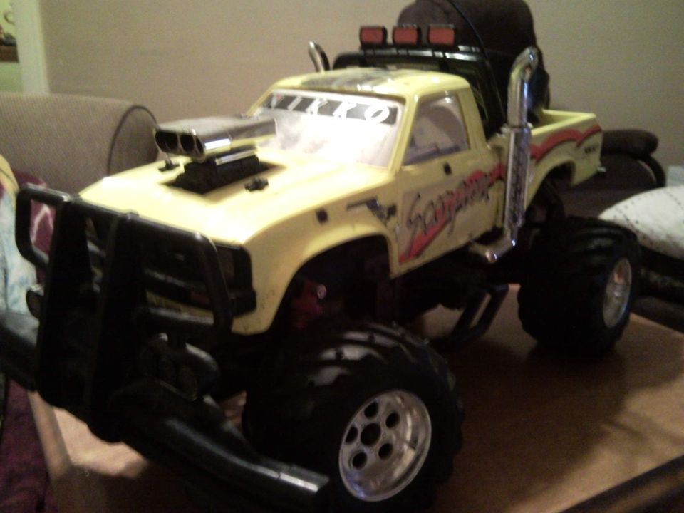 Yellow RC monster truck with scoop and 'Scorpion' graphics