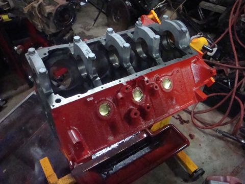 1989 Ford Bronco - A close-up view of an engine block with crankshaft bearings, ready for assembly.