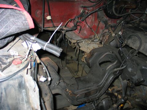 1984 Ford Bronco - Close-up view of engine bay components, including wiring and structural metal parts.
