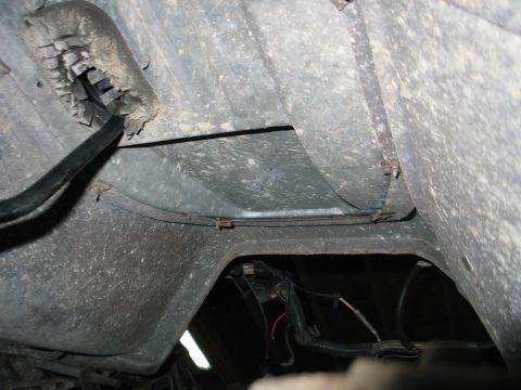 1984 Ford Bronco - Exposed wiring and frame components visible on the underside of a vehicle.