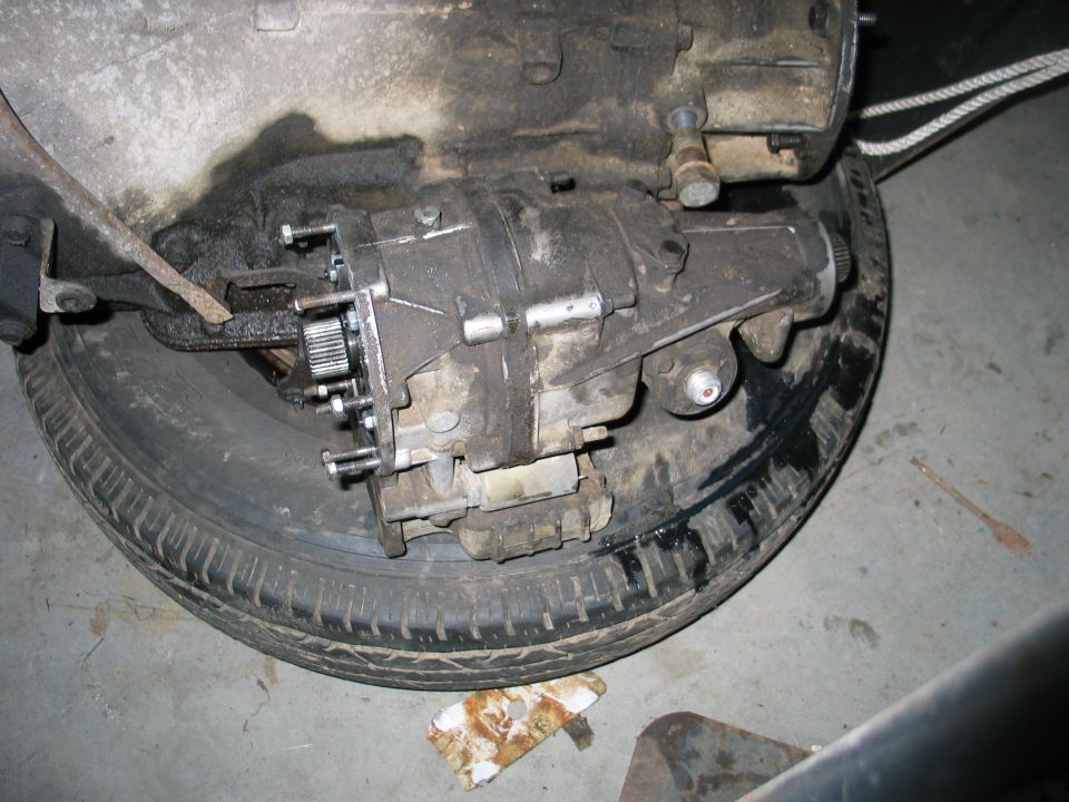 Transfer case assembly resting on a spare tire
