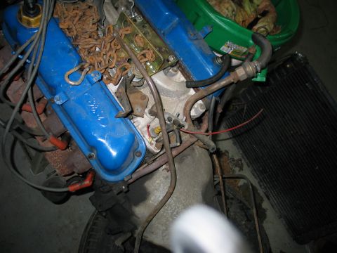 1984 Ford Bronco - Close-up of a Ford V8 engine, showing blue valve covers and various hoses and wires.